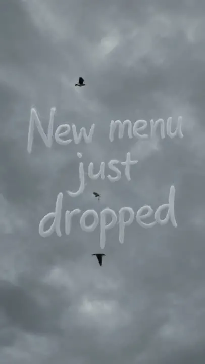 The words “New menu just dropped” written across a cloudy sky
